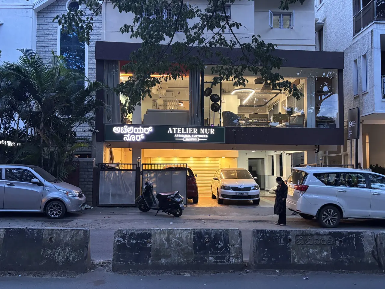 The Atelier Nur storefront on Promenade Road in the evening.
