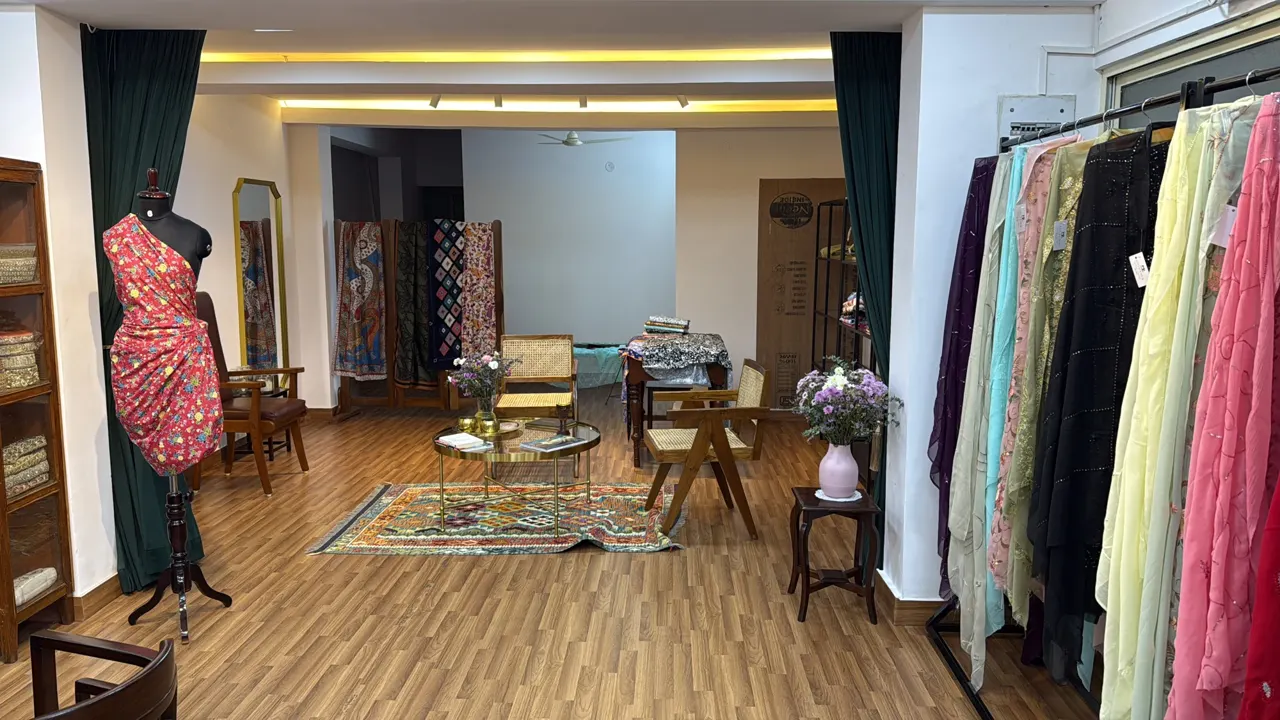 Inside the Atelier Nur showroom, with garment rails, seating and a dress form.